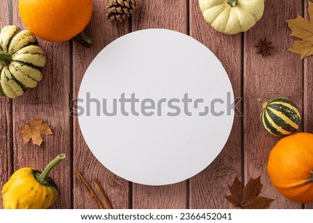 An elevated view captures the essence of a family Thanksgiving dinner set against a rustic fall backdrop. Autumn decorations embellish a brown wooden backdrop, copyspace for text or advertisements Royalty-Free Stock Photo #2366452041