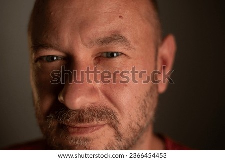 A close-up portrait capturing the friendly and welcoming nature of a 40-year-old unshaved man with a commonplace appearance. Royalty-Free Stock Photo #2366454453