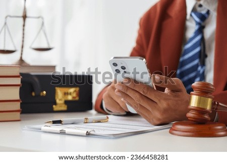A lawyer or notary reads the statute of limitations. Providing advice between male lawyers Revenue Office Law office, judge, legal advisor Lawyers working in the office
 African, American, Indian