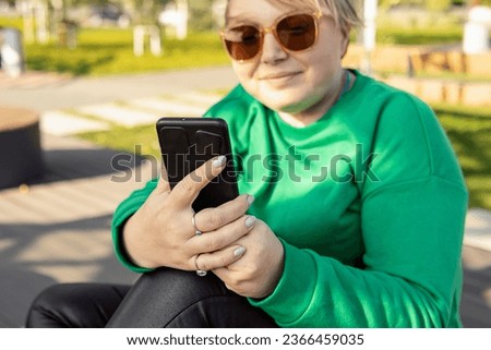 Plus size woman with smartphone. Natural. Female blogger, online work