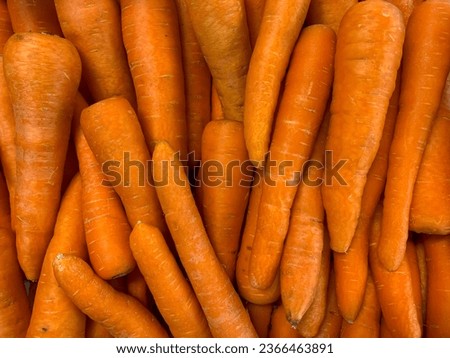 A group of carrot vegetables for sale at the supermarket. Carrot background pattern texture.