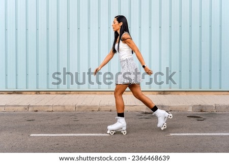 Portrait of a young girl roller skating on the street