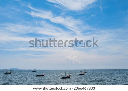 Fishing boats used to catch fish. Located on sea water with slight waves. Used to find food for people who earn a living catching fish. It is considered an important characteristic for people who live