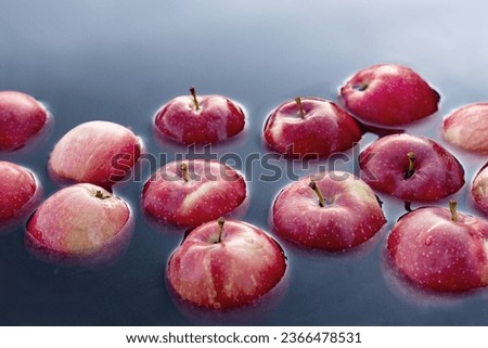 Beautiful red apples float in the water. Royalty-Free Stock Photo #2366478531