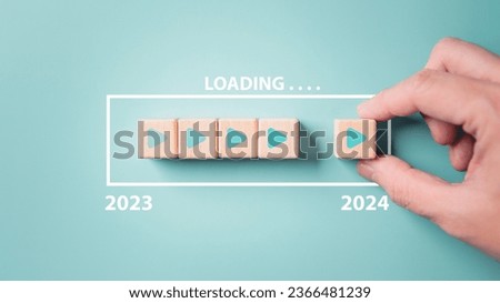 2024 New Year countdown loading. Loading bar on wooden blocks 2023 to 2024 on blue background. The beginning of the starting goal and action plan concept.