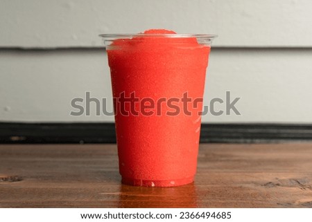 Strawberry slushie in a plastic cup Royalty-Free Stock Photo #2366494685