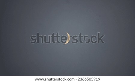 Beautiful waxing crescent moon isolated from gray background. 