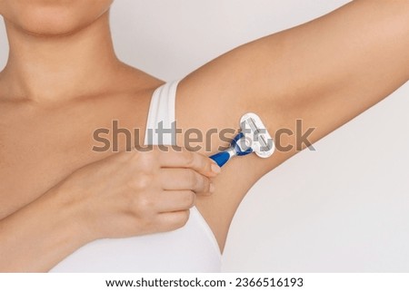 Cropped shot of a young woman shaving her armpit with a razor isolated on a white background. Getting rid of unwanted hair Royalty-Free Stock Photo #2366516193