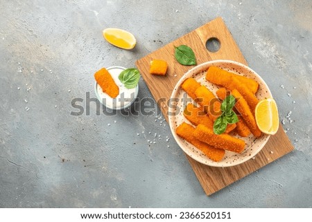Golden roast Fish Sticks Fingers with sauce. banner, menu, recipe place for text, top view. Royalty-Free Stock Photo #2366520151