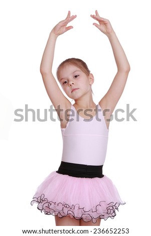 Pretty ballerina dancer wears a pink dress on a white background