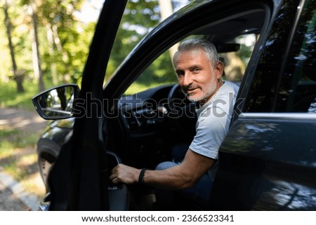 Man customer male buyer client in shirt get out car touch door look camera salon drive choose auto want buy new automobile Royalty-Free Stock Photo #2366523341