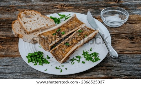 Roasted marrow bones on rustic table from above Royalty-Free Stock Photo #2366525337