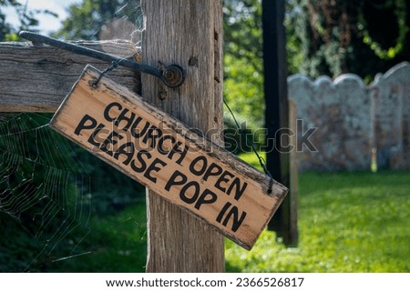 'Church Open, Please pop in' sign on a church gate.