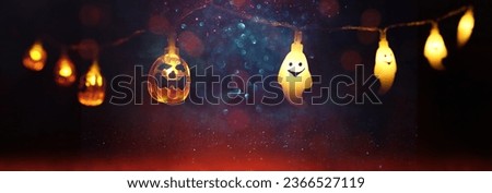 holidays concept of Halloween. Glitter background with colorful garland lights