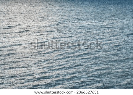 Water surface of the sea with slight waves in the evening, close-up