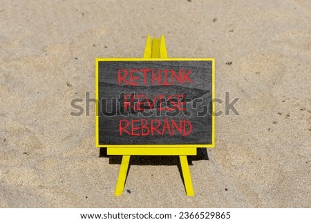 Rethink revise rebrand symbol. Concept word Rethink Revise Rebrand on beautiful blackboard. Beautiful sand beach background. Business brand motivational rethink revise rebrand concept. Copy space.