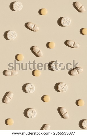 Nature colors pills on a neutral background, top view, copy space.  Seamless pattern