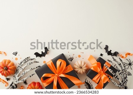 Pleasing close friends with spook-tacular Halloween gift ideas. Top view photo of gift boxes, colorful pumpkins, skeleton arms, spooky decor, confetti on light grey background with promo space