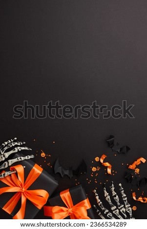Pleasing close friends with spooktacular Halloween gift ideas. Top view vertical photo of presents, skeleton hands, creepy decor, confetti on black background with ad panel