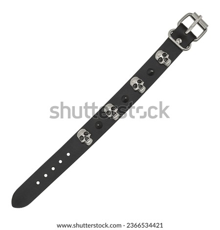 Black leather bracelet with skulls, spikes, pyramids. An accessory for rockers, bikers, metalheads, goths and punks. Steampunk style. Close-up subject photography.