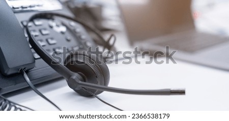 close up soft focus on telephone devices with copy space background at office desk in operation room for customer service support (call center) concept Royalty-Free Stock Photo #2366538179