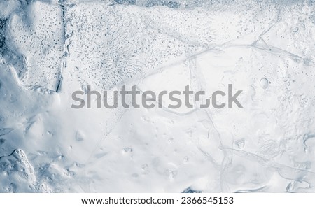 Natural ice texture background with cracks and air bubbles.