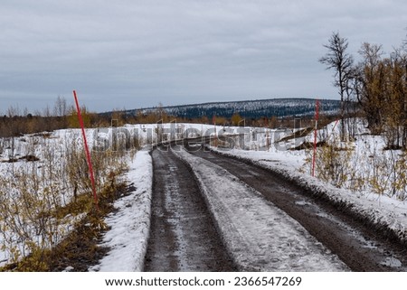 A gravel road in Kiruna, Swedish Lapland. Photographed a september day after snowfall.
