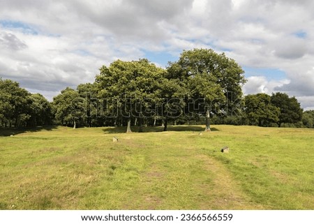Cloudy summer day on the John Muir Way walking trail at the site of the Roman fort at Rough Castle, near Bonnybridge, Central Scotland. Royalty-Free Stock Photo #2366566559