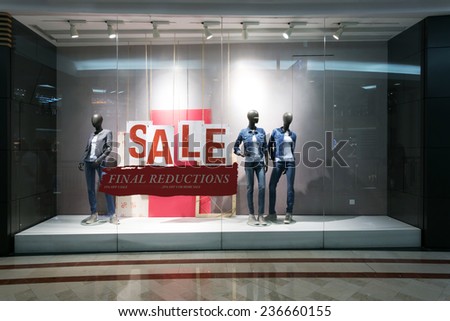 fashion clothes shop display window and sale sign.
