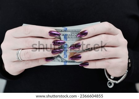 woman's hands holding American dollar paper bills