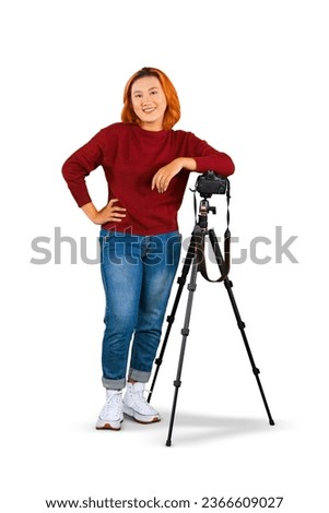 Confident Asian Female photographer standing with tripod isolated on white background