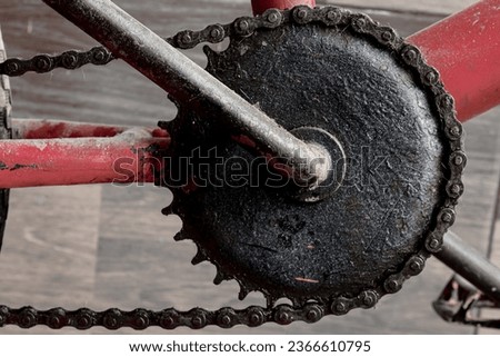 a rusty chain and gears on an old bicycle.
