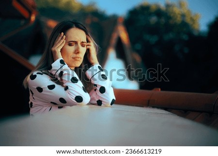 
Stressed Woman Having a Headache in the Morning 
Girl with poor sleep hygiene experiencing nausea and dizziness 
 Royalty-Free Stock Photo #2366613219