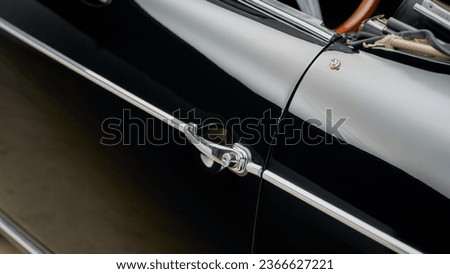 Drivers door handle on a black car Royalty-Free Stock Photo #2366627221