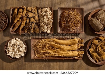 Variety of herbs are displayed on wooden trays in different shapes. For medicine advertising, photography traditional medicine content