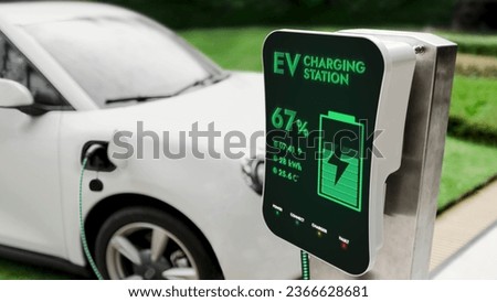 Electric car recharging with EV charger from charging station at public car park. Future innovative rechargeable EV car using alternative clean and sustainable energy. Peruse
