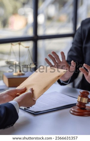 Businessman refusing money that comes with agreement paper, Anti bribery,  businessman taking bribes corruption illegal fraud bribery concept. Royalty-Free Stock Photo #2366631357