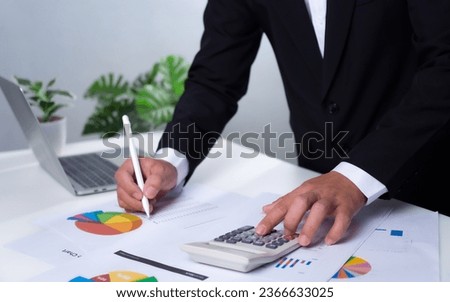 Business development ideas for success and growth. Businessman taps pen on document with calculator for planning future growth of his organization. Finance, management, plans, management, strategy,