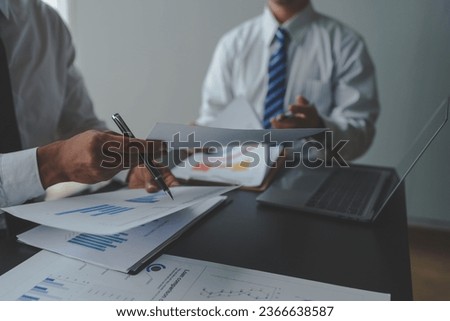 Accountant or financial expert, accountant, male economist There are statistical graphs pointing to account for investment results and income. Calculating company expenses.