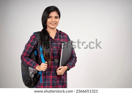Indian Pretty College Girl Or Student Standing With Bag And Books Isolated Over White Background