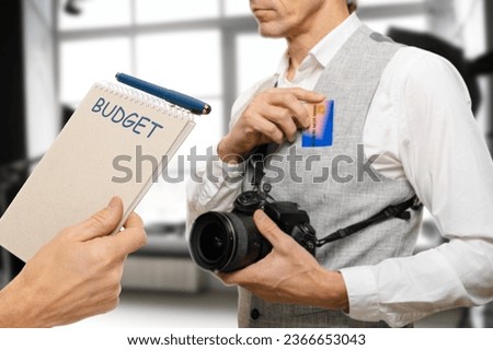 Male professional photographer discussing photo budget cost with client, their shared commitment to achieving a successful outcome while considering the financial aspects of the endeavor.