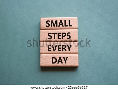 Small Steps Every Day symbol. Wooden blocks with words Small Steps Every Day. Beautiful grey green background. Business and Small Steps Every Day concept. Copy space.