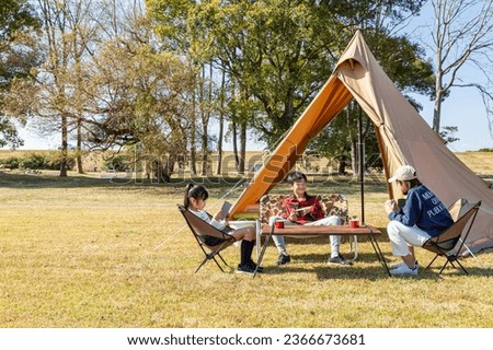 A family enjoying camping on a sunny day.