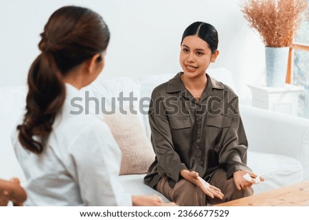 Sad PTSD woman patient in uttermost therapy for mental health with psychologist, depression or grief after life failure. Frustrated trauma young woman talking to a psychologist about emotion in office