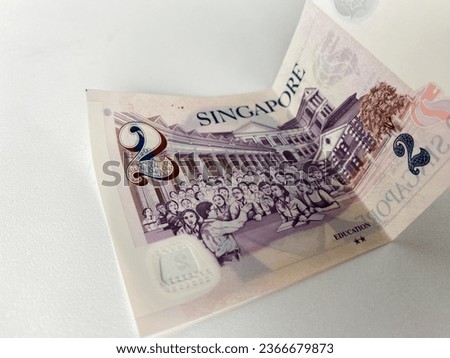 folded two singapore dollar bill isolated white background