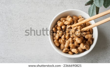 flat lay top view overhead natto or fermented soybean in bowl and chopsticks on table white background. natto or fermented soybean Japanese food. natto ferment soybean white background Royalty-Free Stock Photo #2366690821