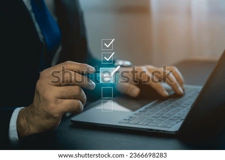 Businessman using digital pen to tick correct sign mark in virtual checkbox screen for quality document control checklist and business approve project. Businessman Take an assessment, questionnaire. Royalty-Free Stock Photo #2366698283