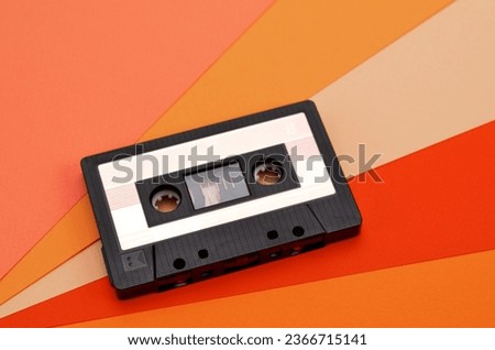 retro tape recorder cassette on a colorful orange background
