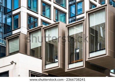 Architectural design of a modern modular multi-story residential metal and glass building composed of rectangular autonomous modules connected with the illusion of the possibility of redevelopment Royalty-Free Stock Photo #2366738241