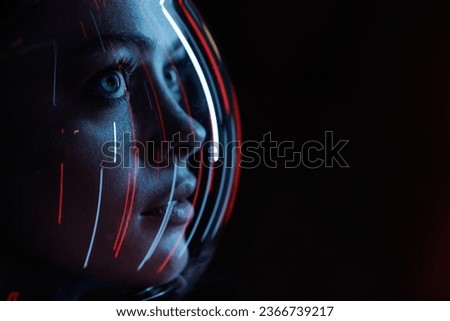 Astronaut in futuristic costume. Girl in glasses of virtual reality while touching air. Augmented reality game, future technology, AI concept. Dark background